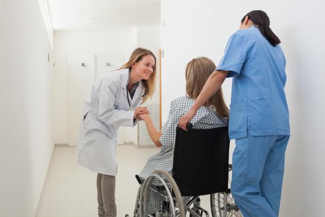 doctor talking to patient in wheelchair